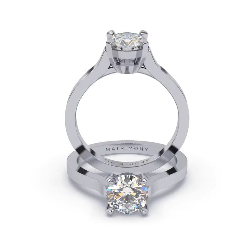 Hermoso anillo de compromiso solitario con piedras laterales y diamante redondo. Este modelo se encuentra disponible con piedras de zirconia ó diamante y en oro de 9k, 14k, 18k ó platino.